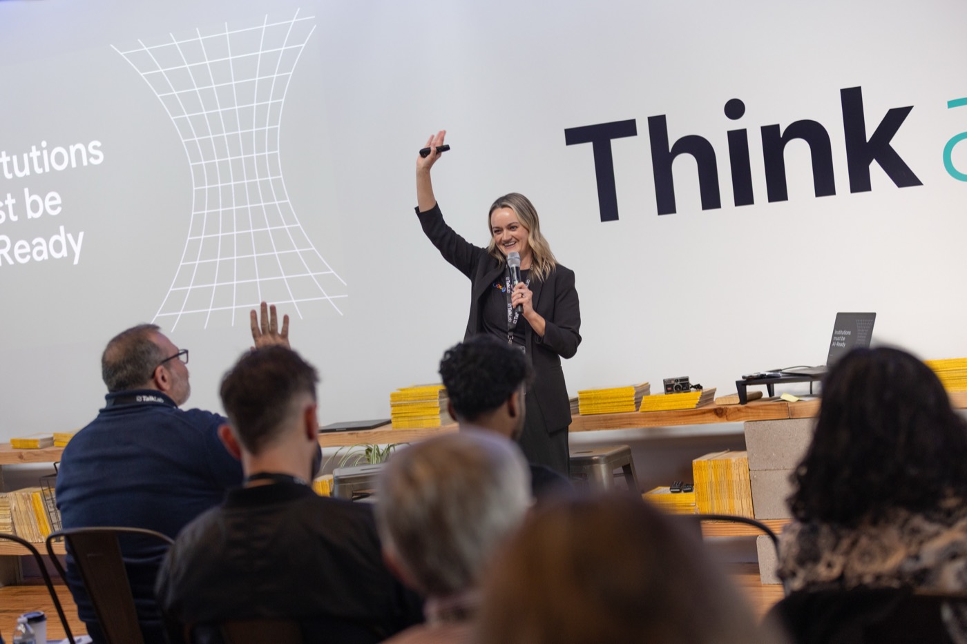 Engaged audience asking questions at a past AI event